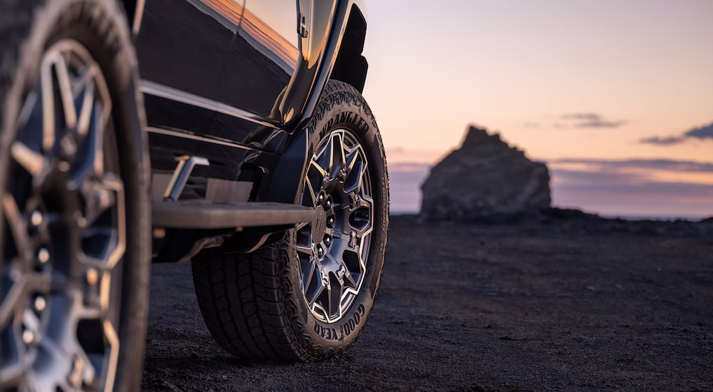 Wheels and tires on a 2024 GMC Hummer EV at dusk.