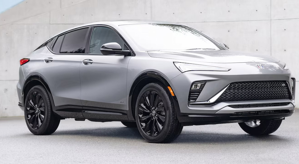 A silver 2025 Buick Envista ST parked in front of a concrete wall.