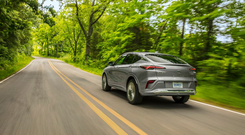 A silver 2025 Buick Envista driving on a highway.