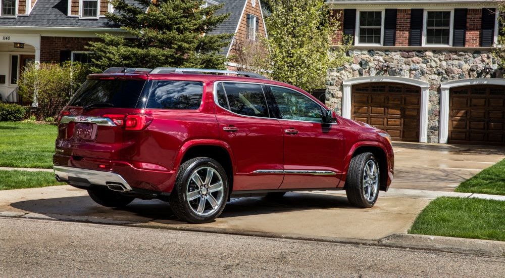 Rear of a red 2018 GMC Acadia parked on a driveway.