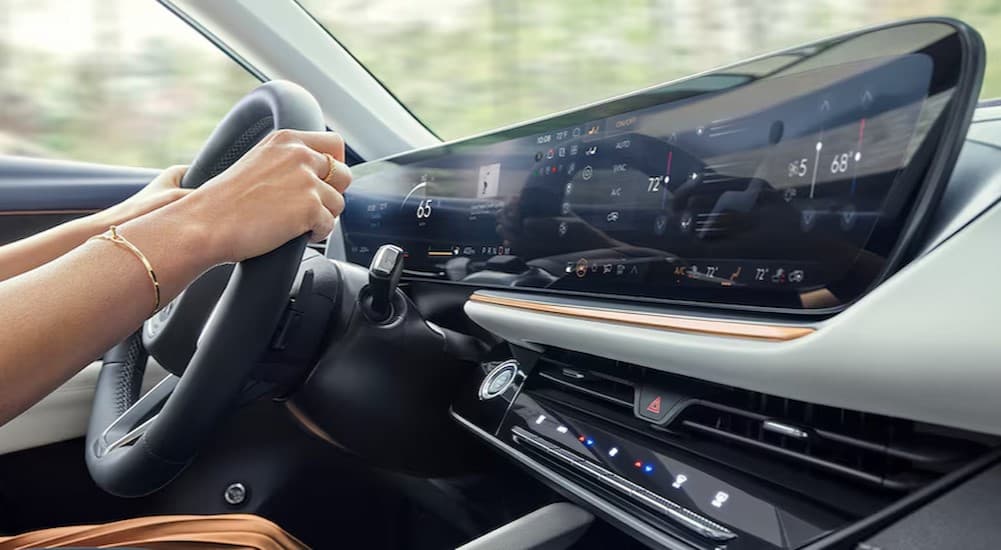 A person driving in a 2024 Buick Envision.