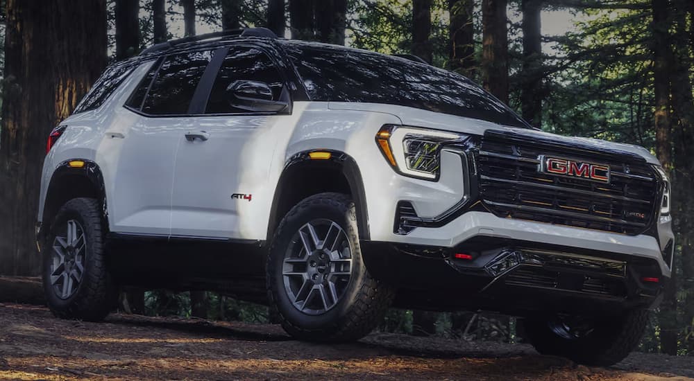 A white 2026 GMC Terrain AT4 parked in the woods