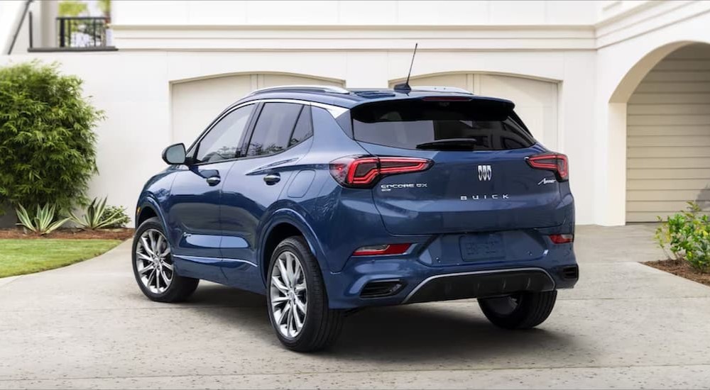 A blue 2023 Buick Encore GX shown parked in a driveway from the rear.