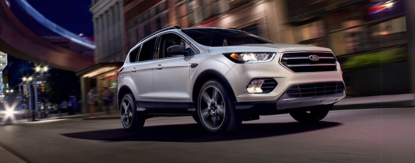 White 2019 Ford Escape driving through a city.