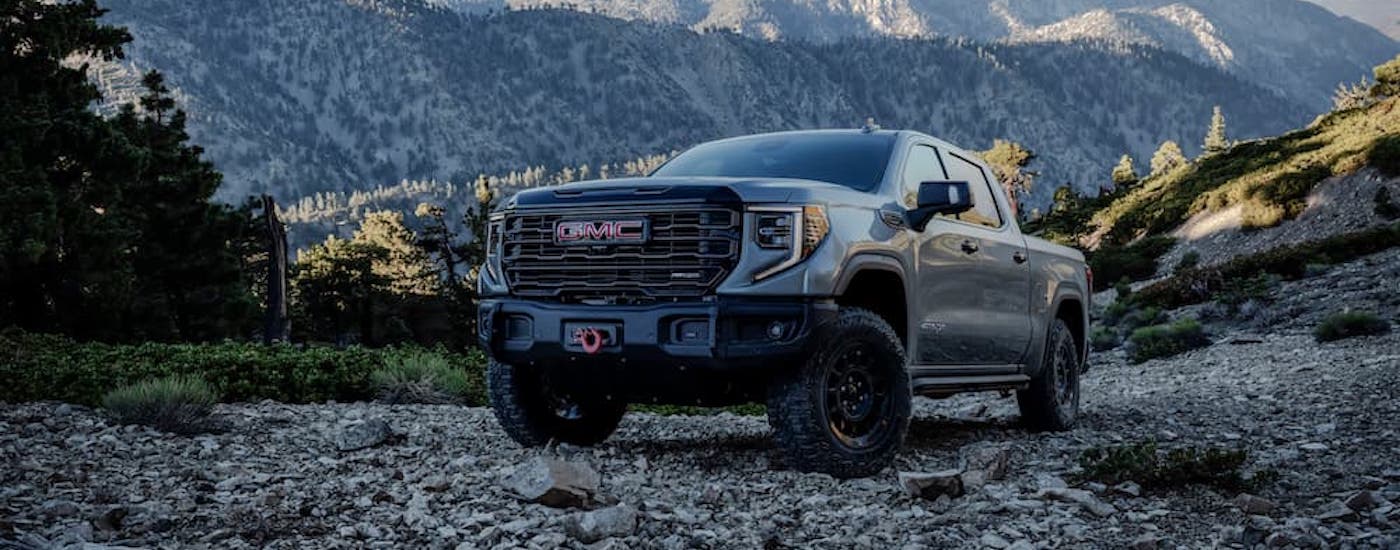 A grey 2023 GMC Sierra 1500 AT4x parked off-road.