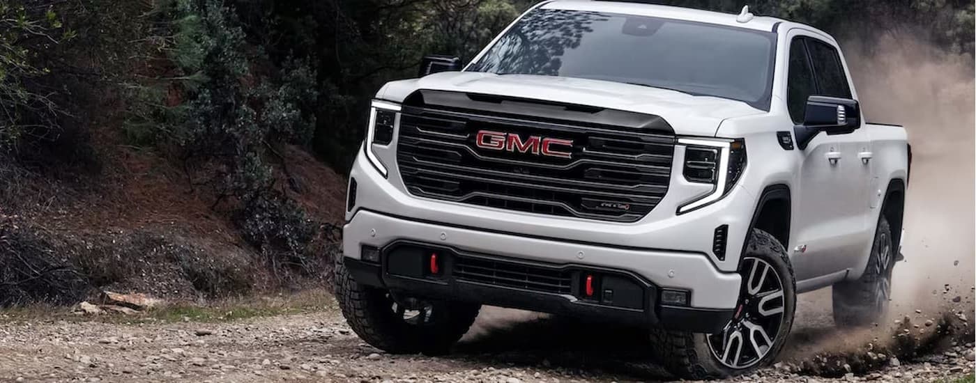A white 2025 GMC Sierra 1500 AT4X parked off-road.