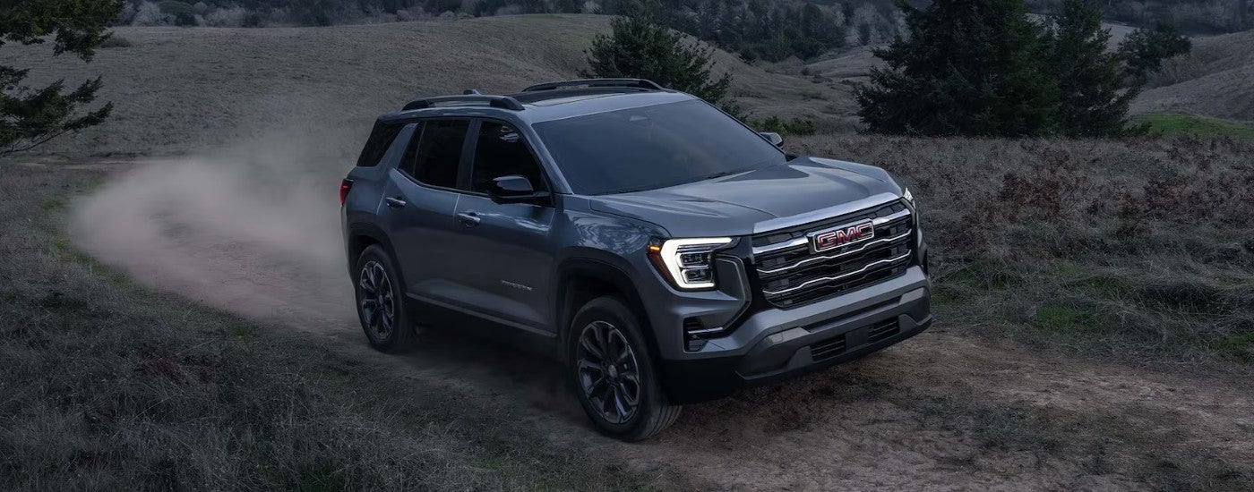 Grey 2026 GMC Terrain Elevation driving on a trail