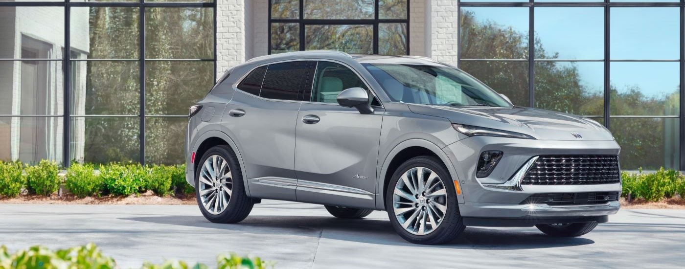 A grey 2024 Buick Envision Avenir is shown from the side.