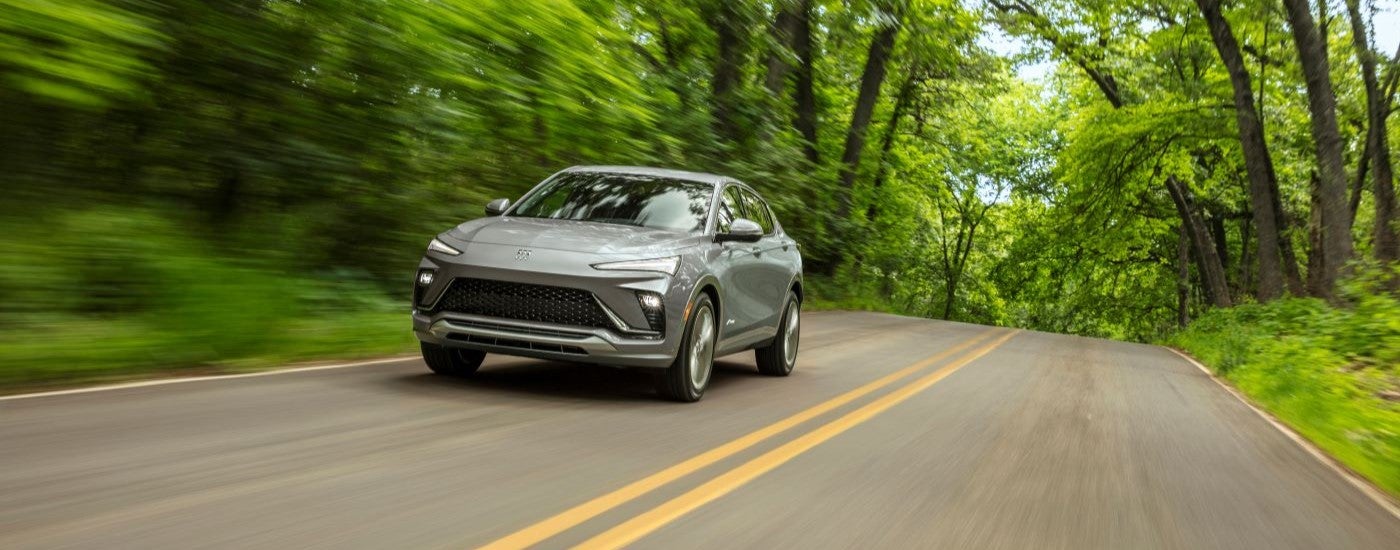 A grey 2024 Buick Envista Avenir leaving a Buick dealer.