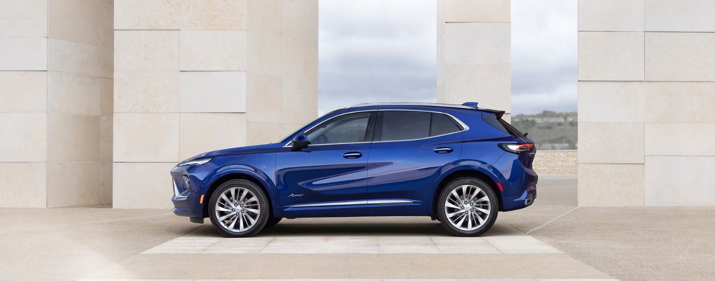 Side view of a blue 2025 Buick Envision Avenir at a Buick dealer near Wayne.