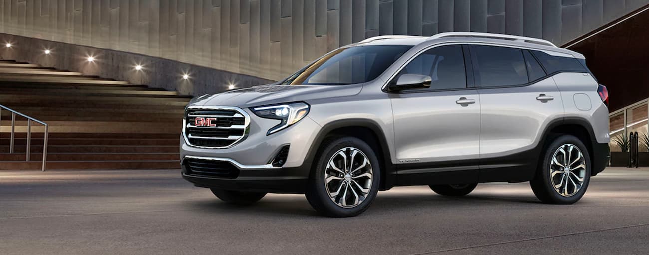 A silver 2020 GMC Terrain parked in a showroom at a GMC dealer near Belleville.