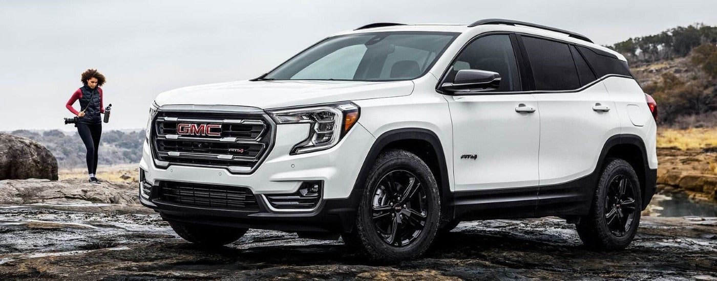 A white 2024 GMC Terrain AT4 parked off-road.