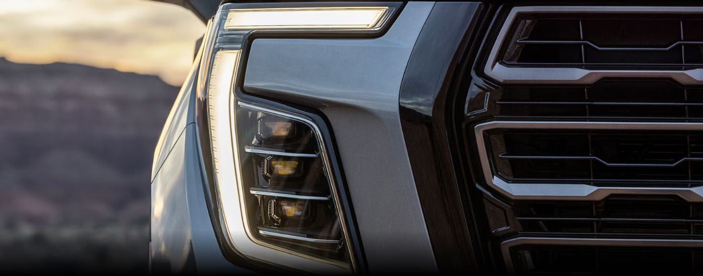 The grille of a grey 2026 GMC Yukon.