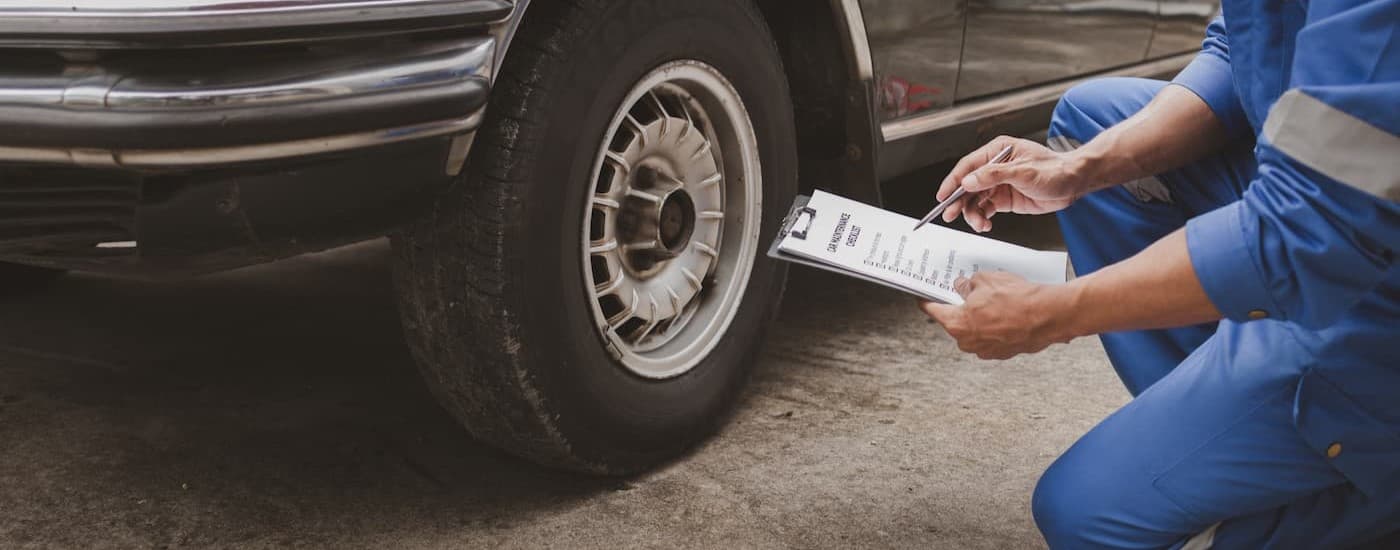 A technician inspecting a tire.