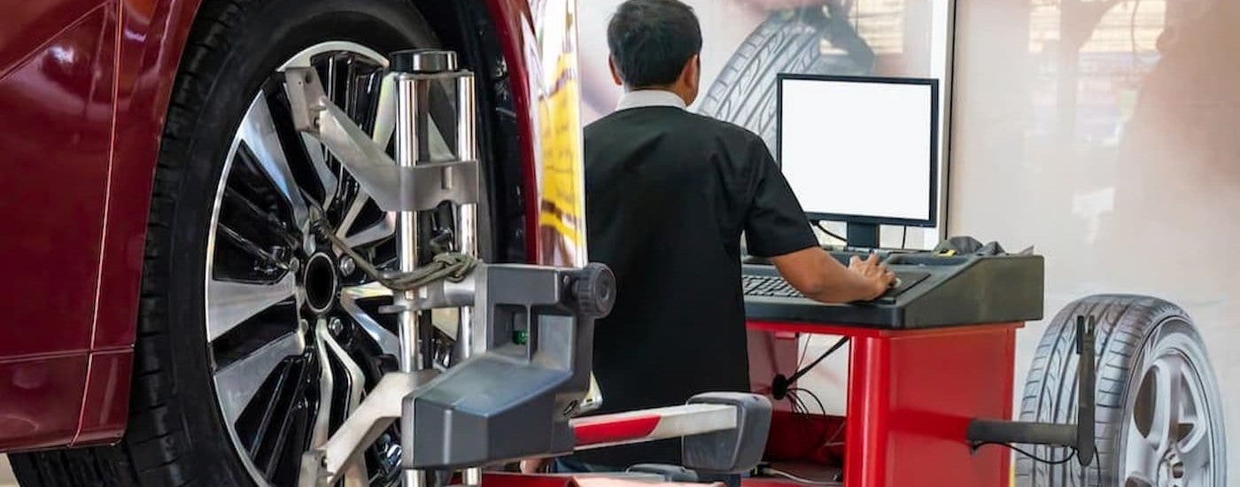 A technician performing a tire alignment.